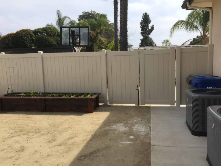 Tan vinyl privacy fence and gate installed in a San Diego backyard