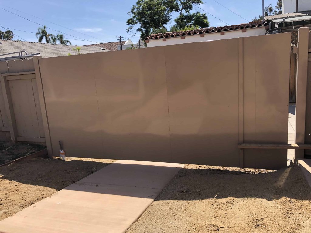 Solid all-metal privacy swing gate in a tan powder coat with no wood infill