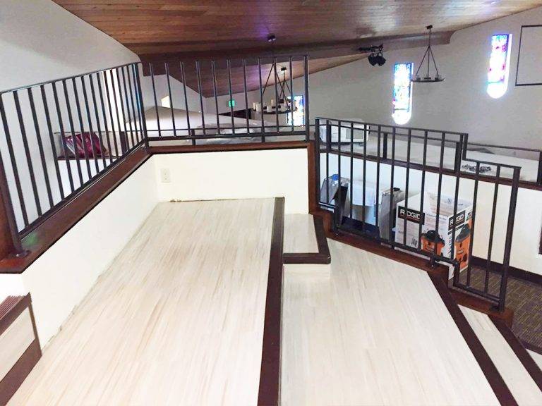 Interior iron railing along a mezzanine landing inside a San Diego home