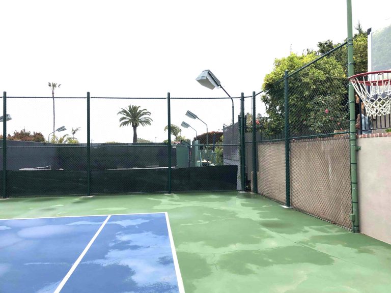 Tall chain link fencing enclosing a sport court in San Diego