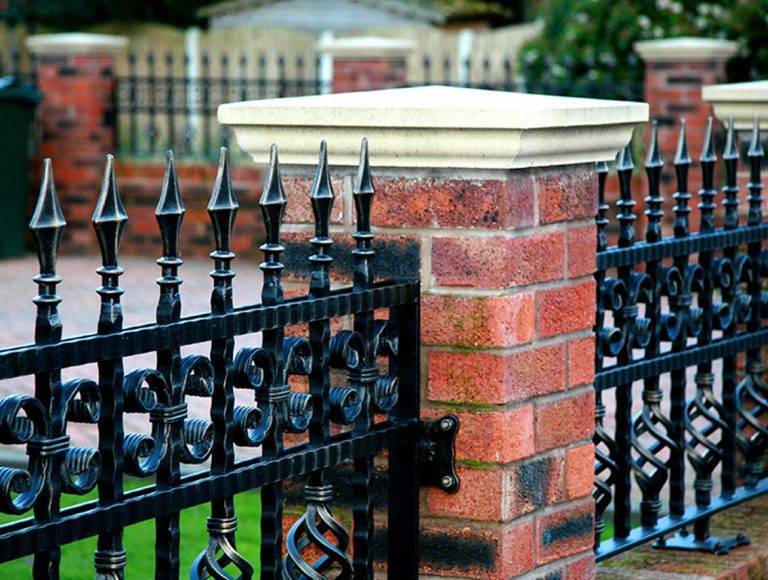 New ornamental iron fence with brick pillars installed in San Diego