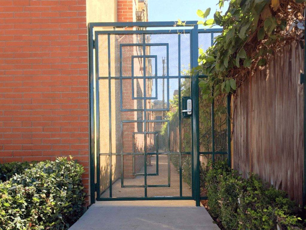 Custom powder-coated iron side gate with geometric pattern