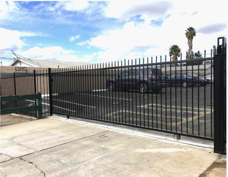Automated iron slide gate securing a commercial lot in San Diego